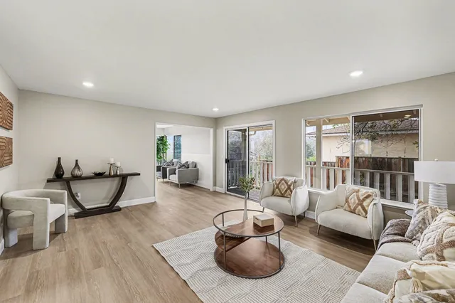 a living room with furniture and wooden floor
