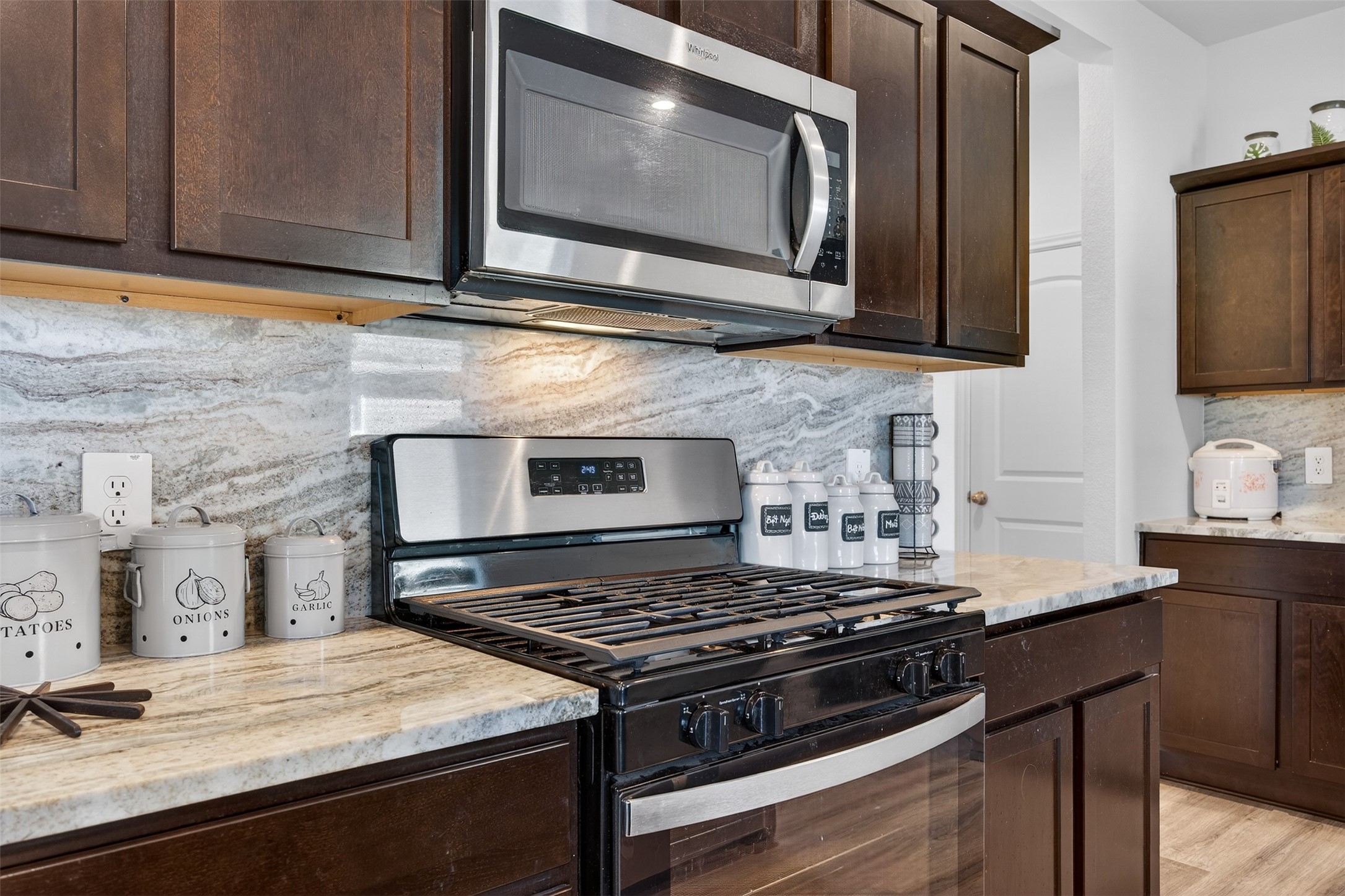 1702 Legacy Hills Drive Houston, TX 77067 - Photo 14 of 43 a kitchen with stainless steel appliances granite countertop a stove and a microwave