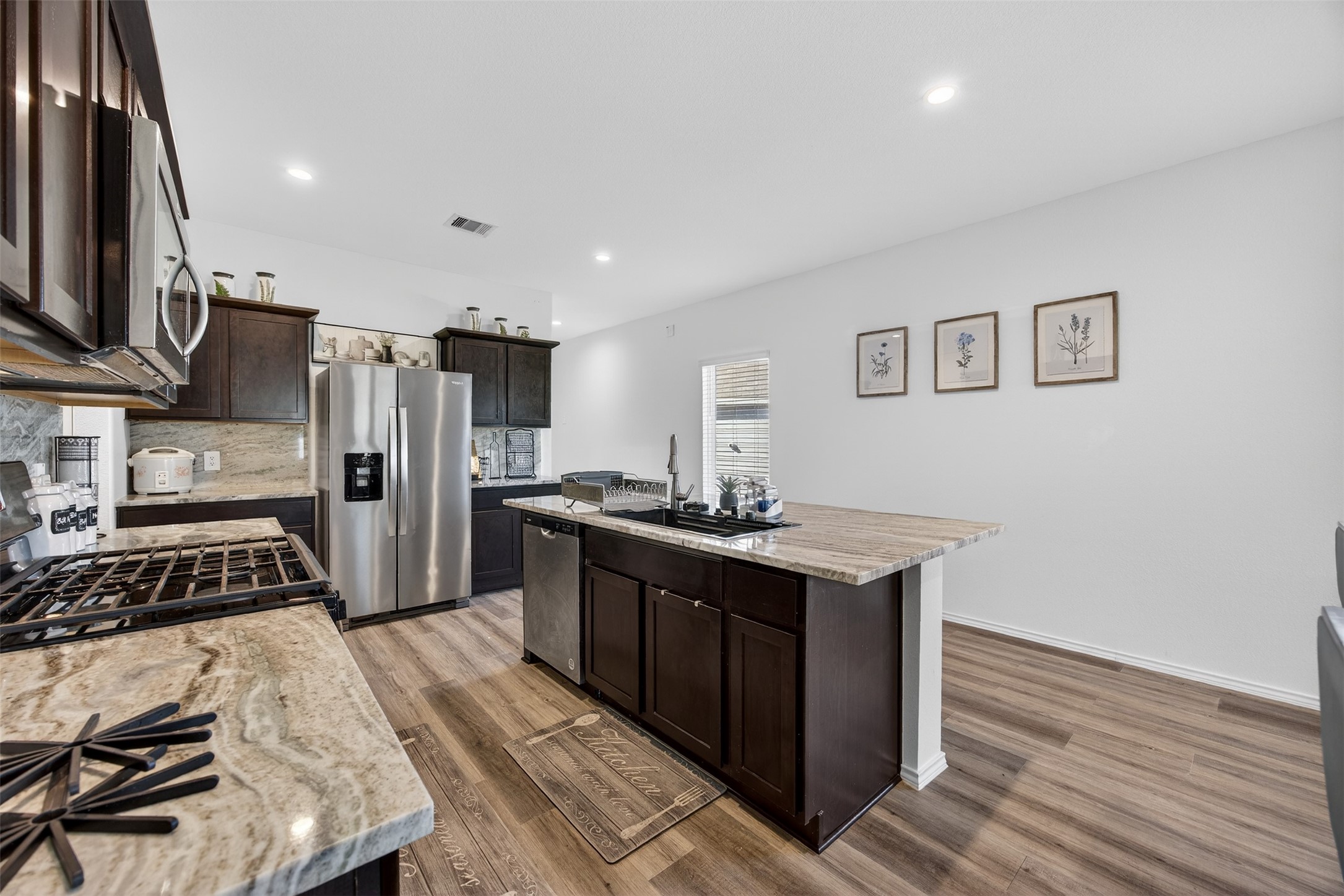 1702 Legacy Hills Drive Houston, TX 77067 - Photo 15 of 43 a kitchen with stainless steel appliances a stove refrigerator and a sink