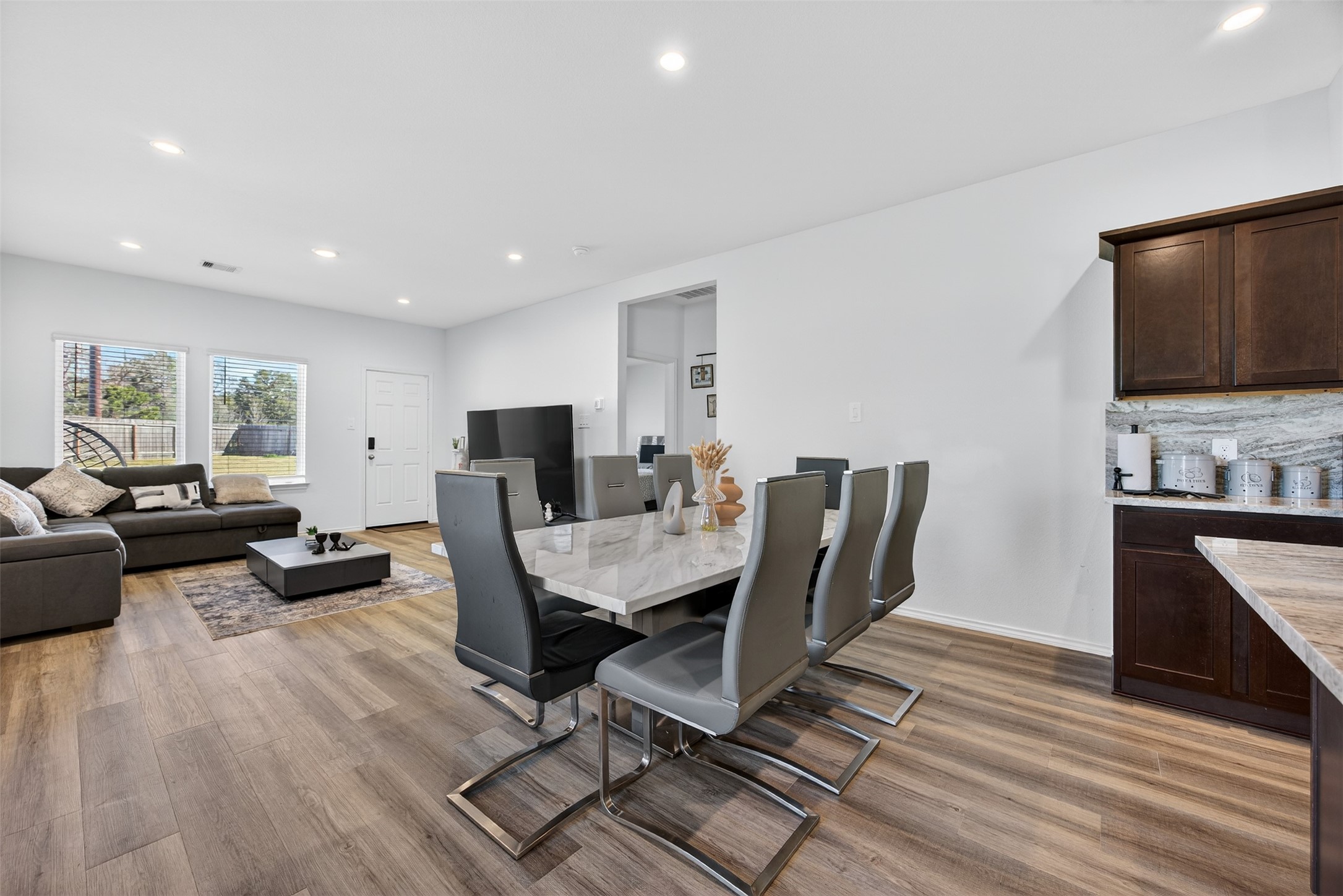 1702 Legacy Hills Drive Houston, TX 77067 - Photo 17 of 43 a view of a dining room with furniture a rug and wooden floor