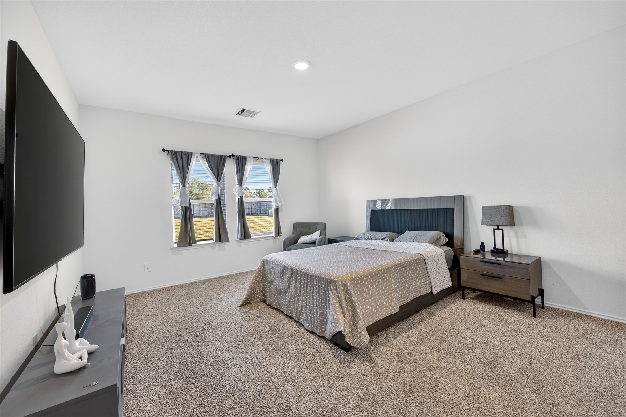 1702 Legacy Hills Drive Houston, TX 77067 - Photo 19 of 43 a spacious bedroom with a bed and a flat screen tv
