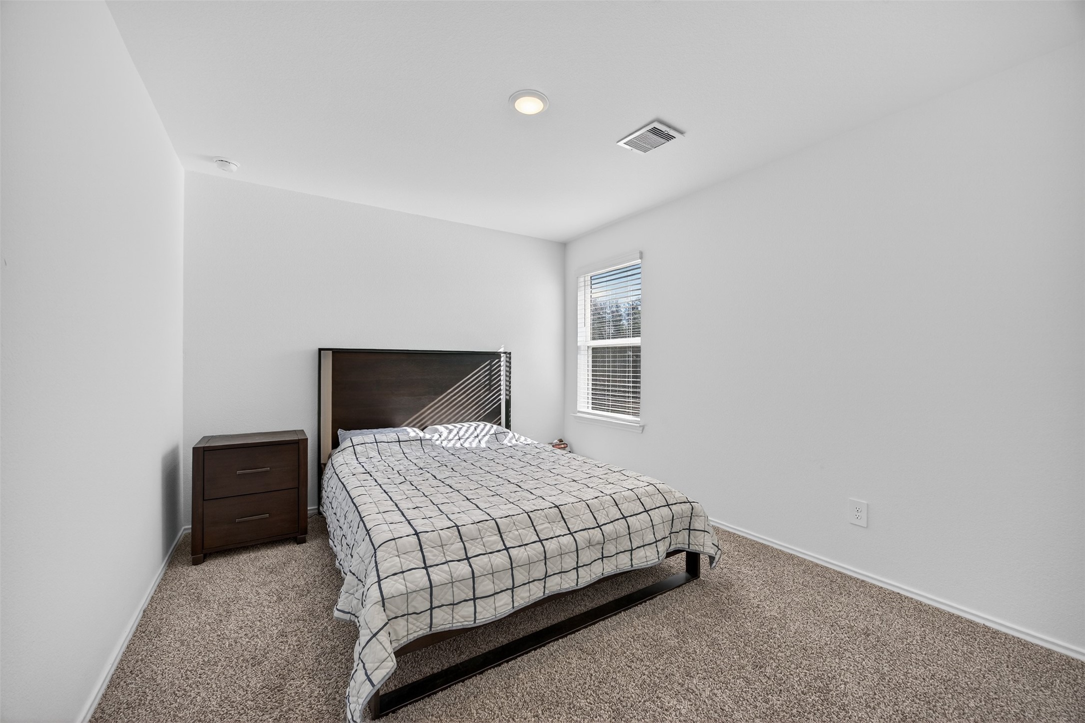 1702 Legacy Hills Drive Houston, TX 77067 - Photo 29 of 43 a bedroom with a bed and a night stand