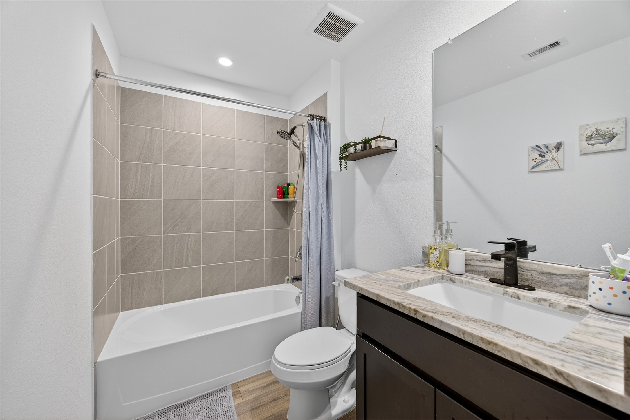 1702 Legacy Hills Drive Houston, TX 77067 - Photo 33 of 43 a bathroom with a granite countertop sink a toilet a mirror and shower
