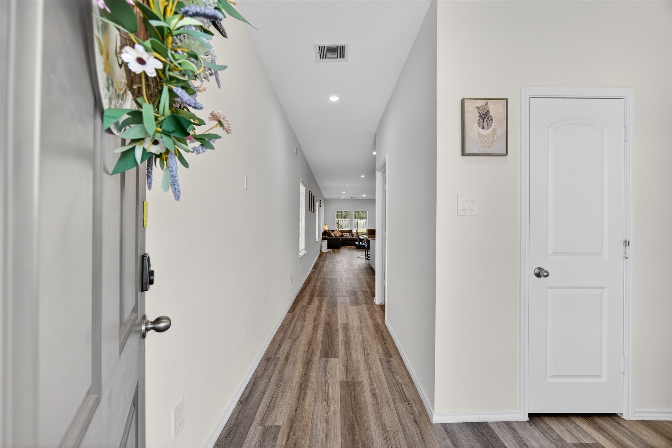 1702 Legacy Hills Drive Houston, TX 77067 - Photo 7 of 43 a view of a hallway with wooden floor and a potted plant