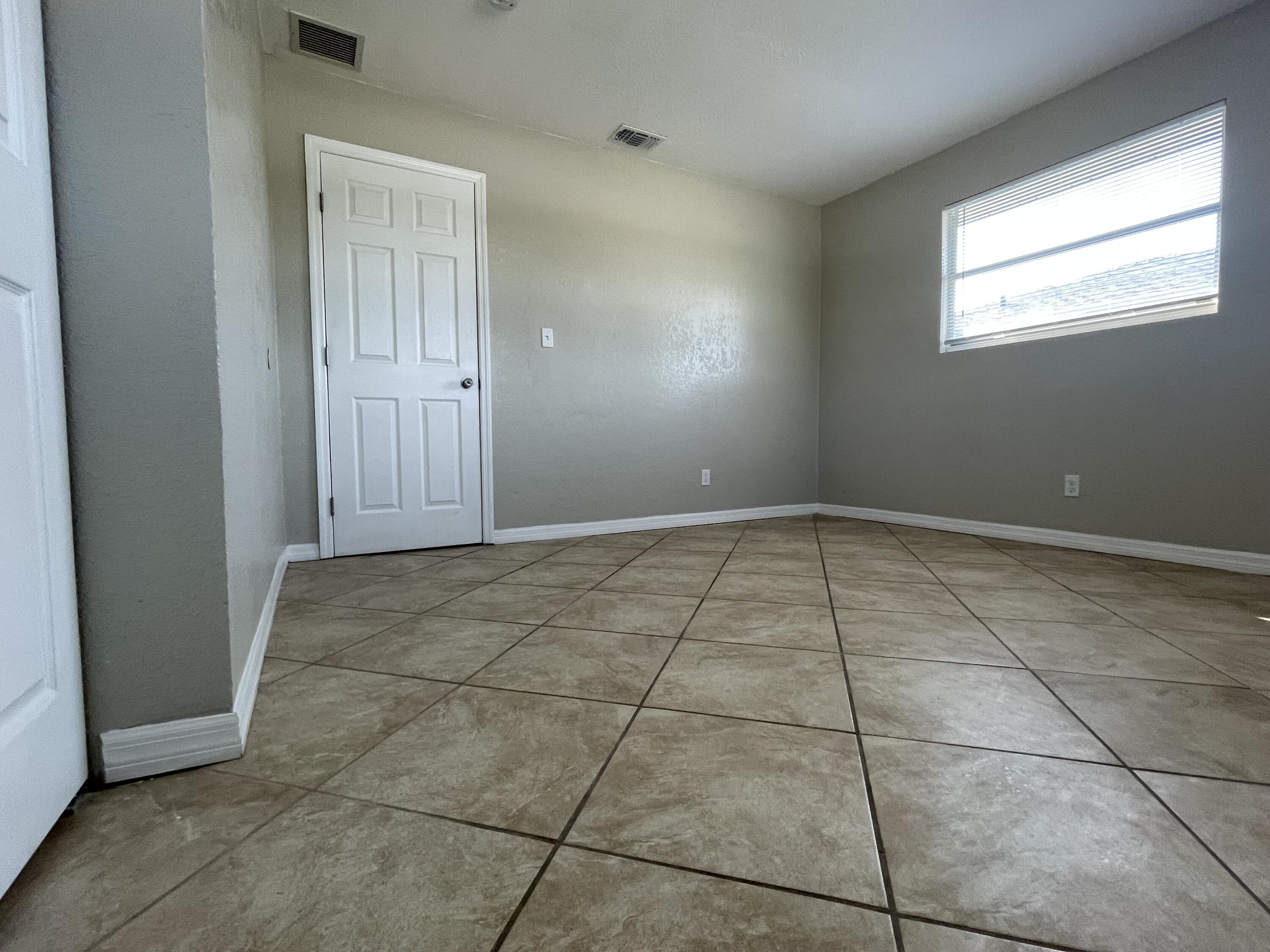 2880 Harson Way Fort Pierce, FL 34946 - Photo 26 of 40 a view of an empty room with windows