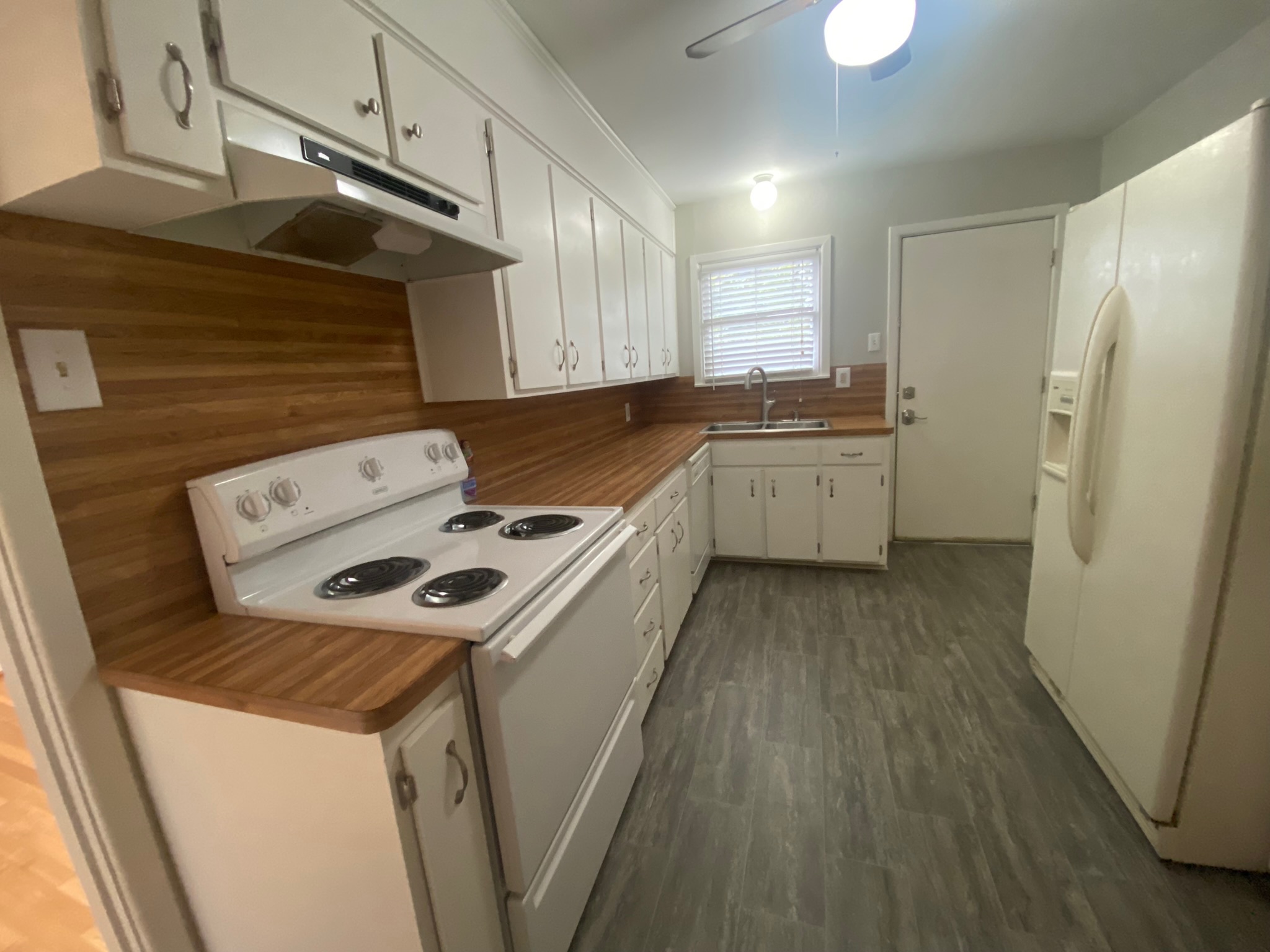1818 South 39th Street Temple, TX 76504 - Photo 2 of 14 Kitchen with white appliances, white cabinets, dark wood finished floors, and a ceiling fan