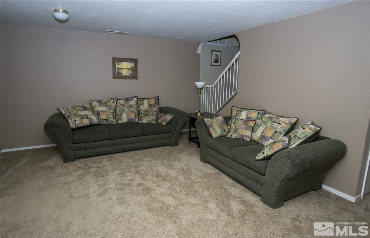 17180 Touraco Street Reno, NV 89508 - Photo 4 of 12 a living room with furniture and a couch