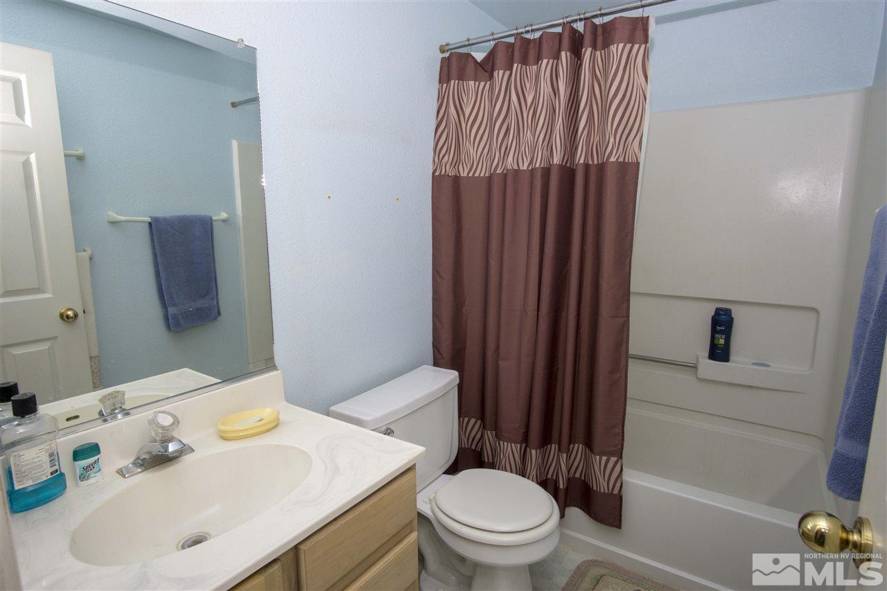 17180 Touraco Street Reno, NV 89508 - Photo 6 of 12 a bathroom with a sink toilet and shower