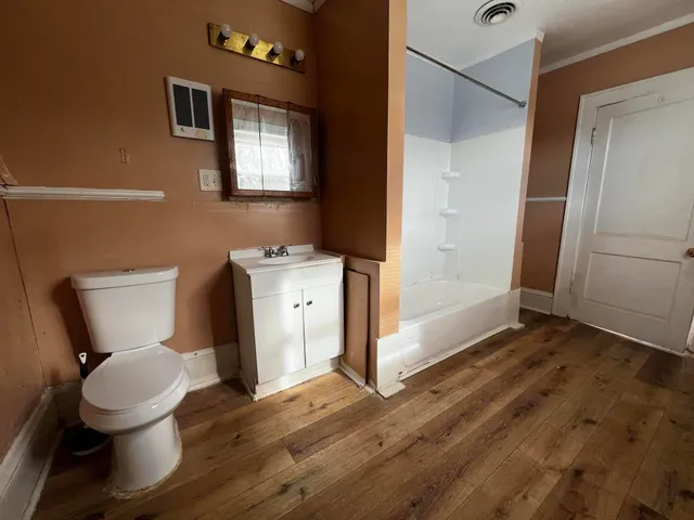 a bathroom with a toilet and a shower
