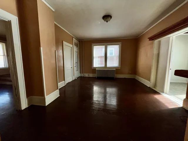 a view of a livingroom with wooden floor and a window