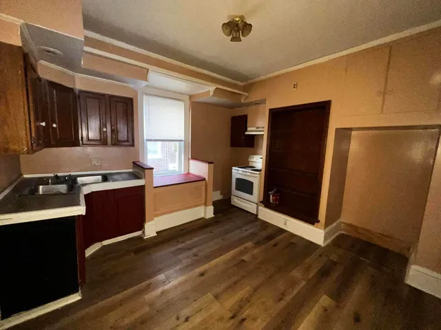 a kitchen with stainless steel appliances granite countertop a refrigerator and a stove