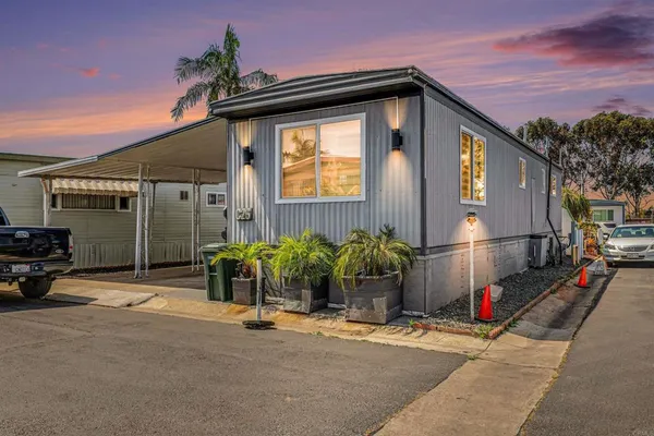 a view of a car park in front of a house