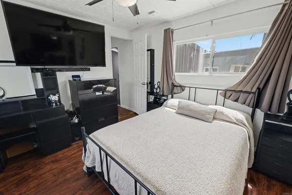 a bedroom with a bed and a flat screen tv
