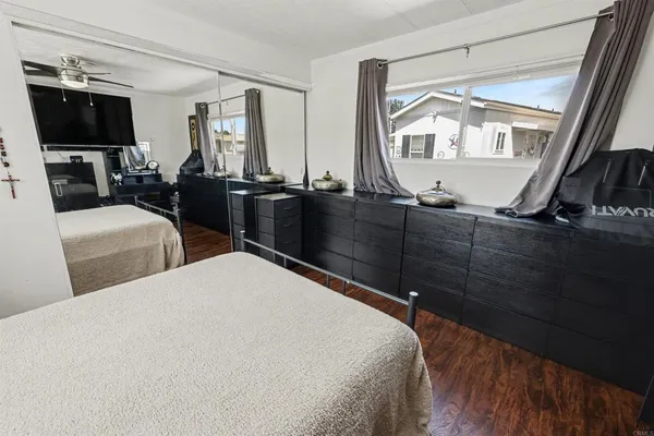 a living room with furniture a flat screen tv and floor to ceiling window