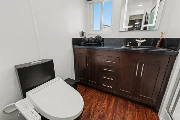 a kitchen with a sink a toilet and mirror