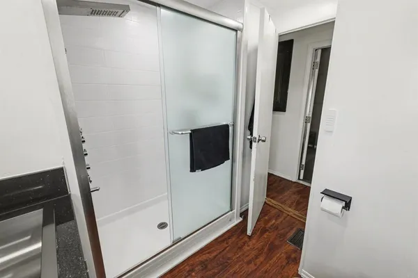 a bathroom with a shower and a mirror