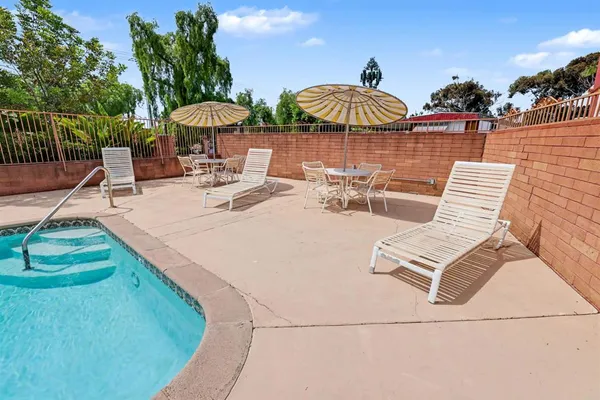 a view of a swimming pool with outdoor seating