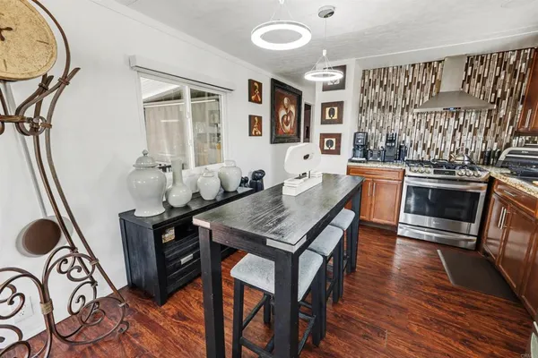 a dining room with furniture and wooden floor