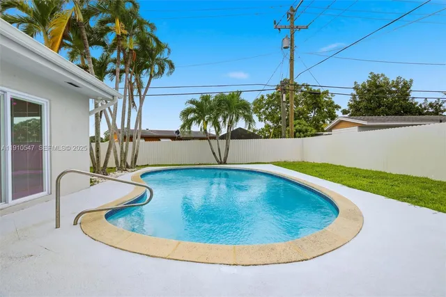 a white house with a big yard and large trees