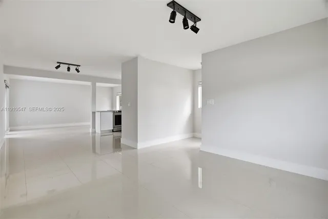 a kitchen with a refrigerator and a sink