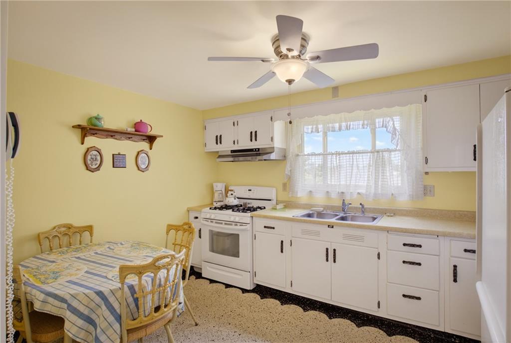 186 William Street McKees Rocks, PA 15136 - Photo 15 of 45 a kitchen that has a lot of cabinets in it and wooden floors