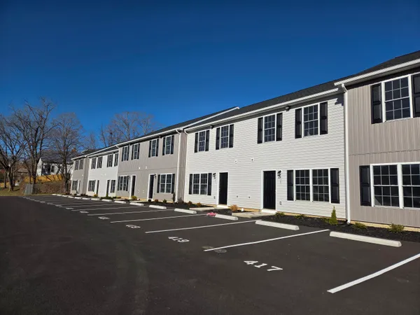 a view of a house with a yard and sitting area