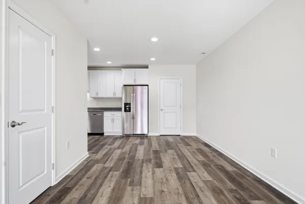 a kitchen with granite countertop a refrigerator stove and microwave