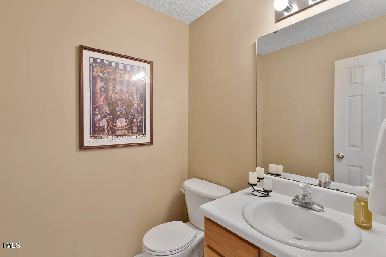 1060 Alderman Circle Raleigh, NC 27603 - Photo 13 of 30 a bathroom with a toilet sink and mirror