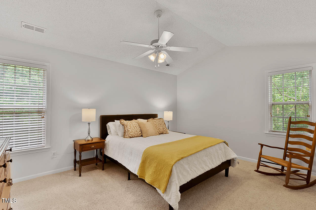 1060 Alderman Circle Raleigh, NC 27603 - Photo 14 of 30 a bedroom with a bed and a chandelier