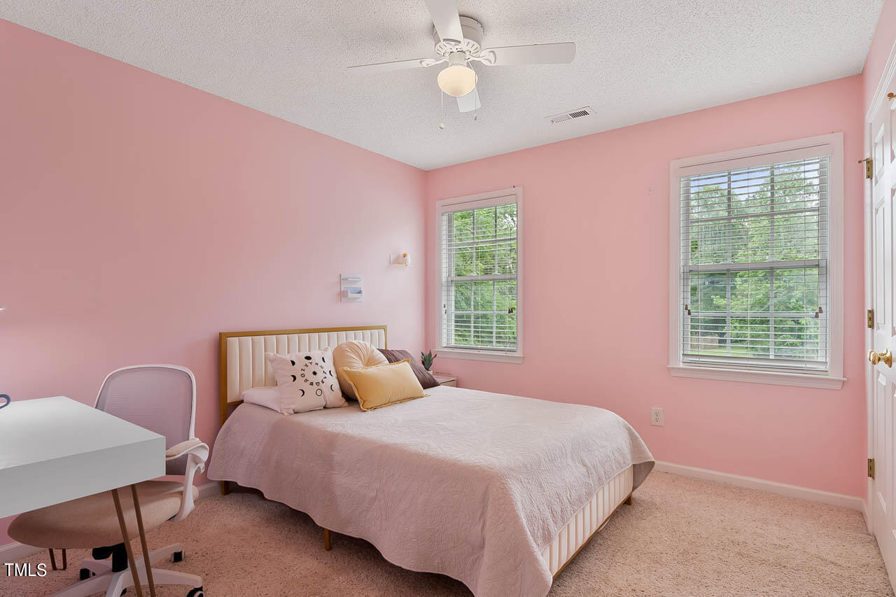 1060 Alderman Circle Raleigh, NC 27603 - Photo 18 of 30 a bedroom with a bed dresser and a window