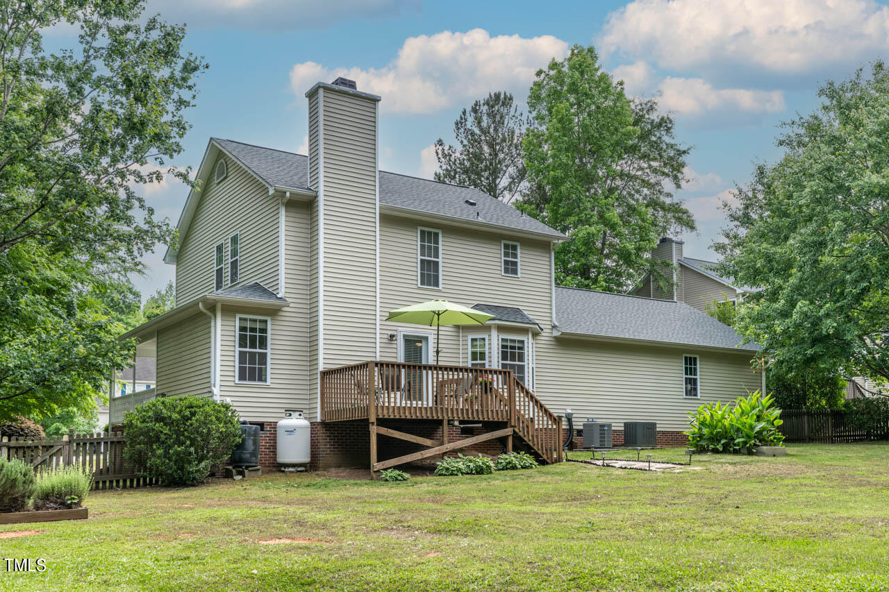 1060 Alderman Circle Raleigh, NC 27603 - Photo 25 of 30 a front view of a house with a yard and potted plants