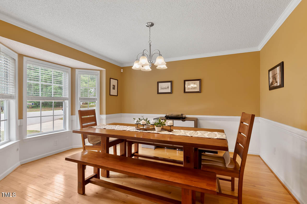 1060 Alderman Circle Raleigh, NC 27603 - Photo 4 of 30 a view of a dining room with furniture window and wooden floor