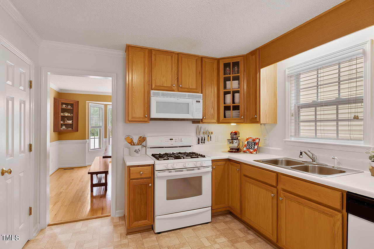 1060 Alderman Circle Raleigh, NC 27603 - Photo 10 of 30 a kitchen with stainless steel appliances granite countertop a stove sink and cabinets