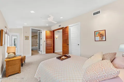 a bedroom with furniture and a lamp