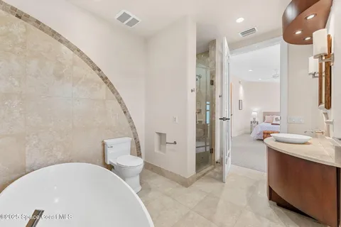 a bedroom with bed and a couch