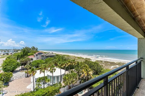 a view of a big room with large windows and a yard