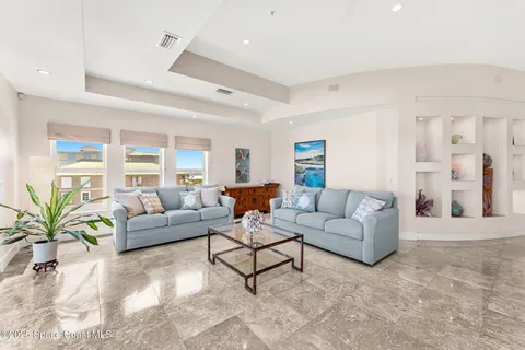 a view of a dining room with furniture and a potted plant
