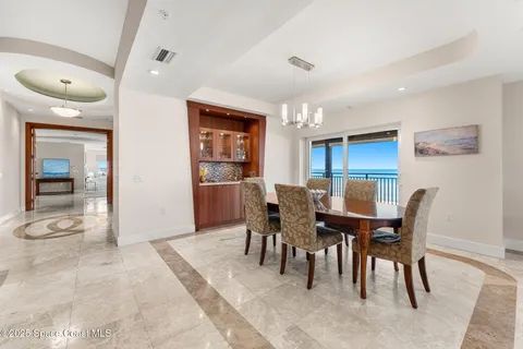 a living room with furniture a dining table and kitchen view