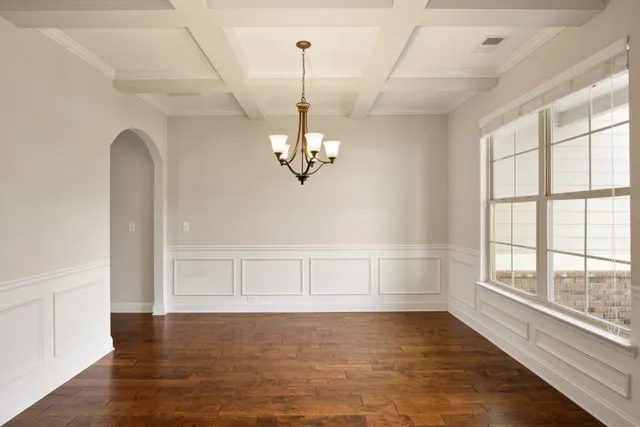 a view of an empty room kitchen and a fireplace