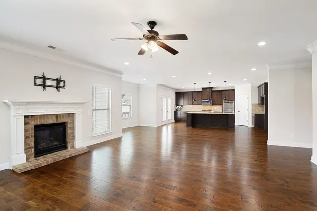 a kitchen with granite countertop a sink a counter space appliances and cabinets