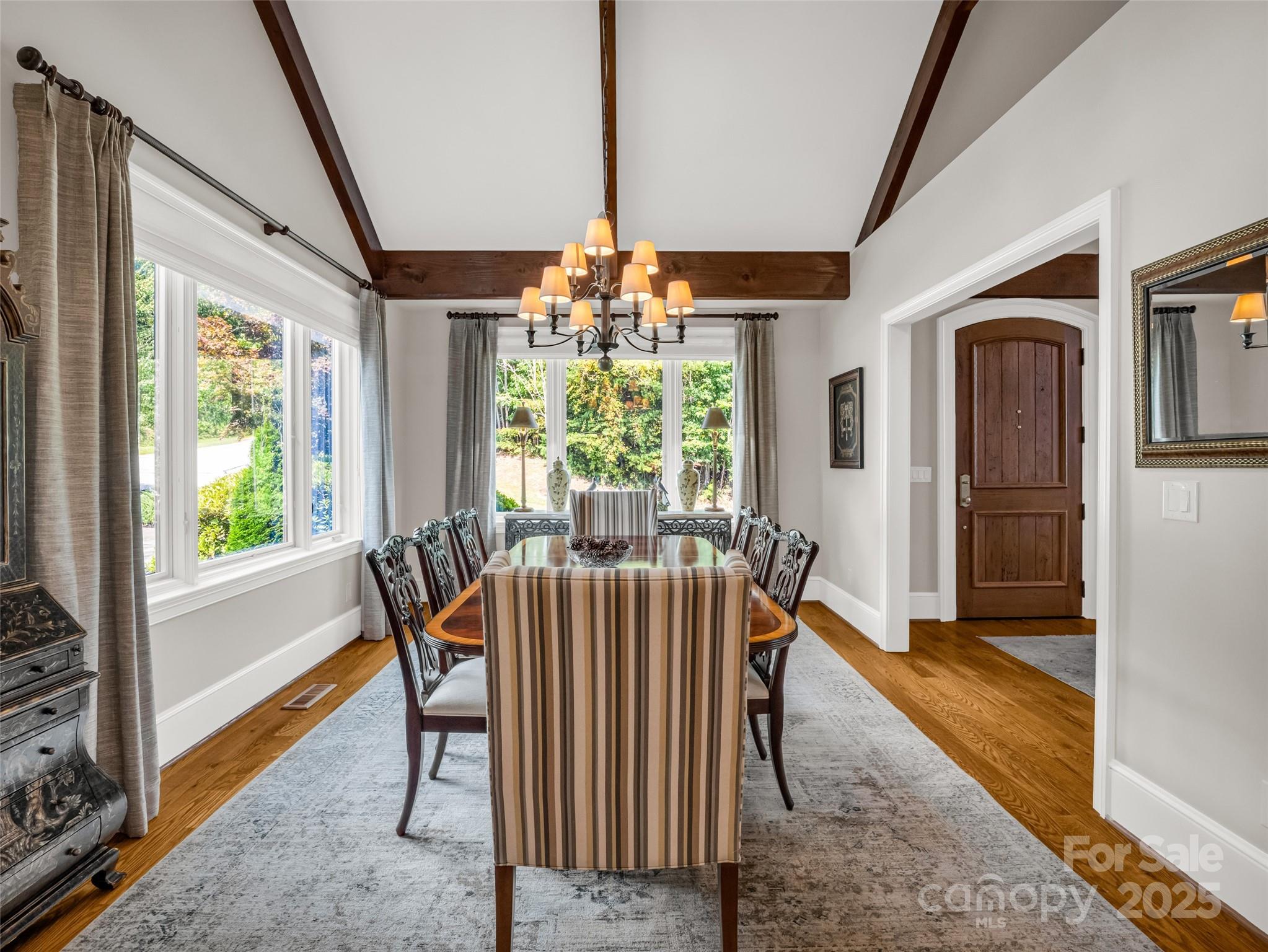 2435 Deep Gap Farm Road East Mill Spring, NC 28756 - Photo 11 of 44 a dining room with furniture a chandelier and wooden floor