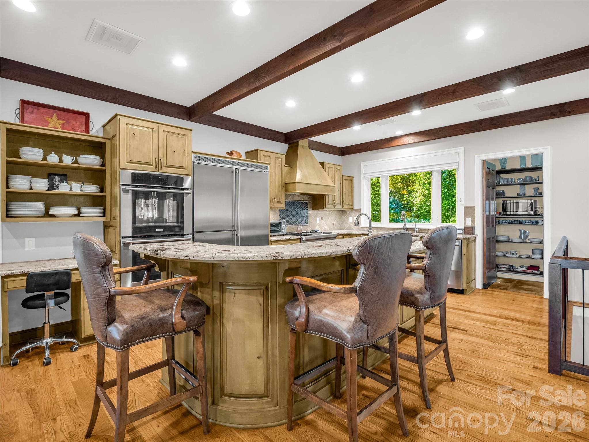 2435 Deep Gap Farm Road East Mill Spring, NC 28756 - Photo 14 of 42 a kitchen with stainless steel appliances granite countertop a table chairs and a refrigerator