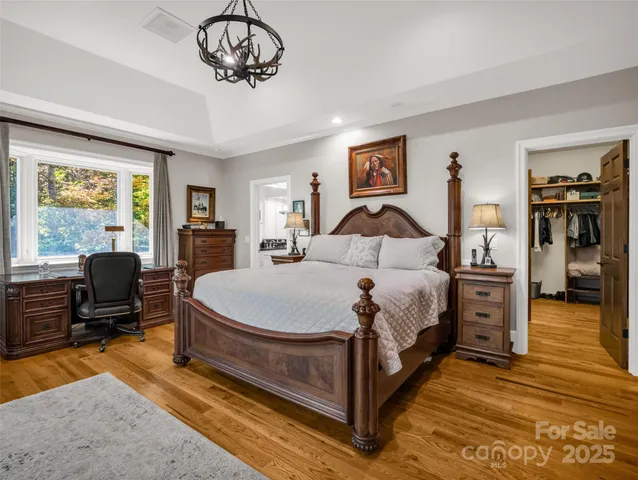 a bedroom with a bed a couch and dresser