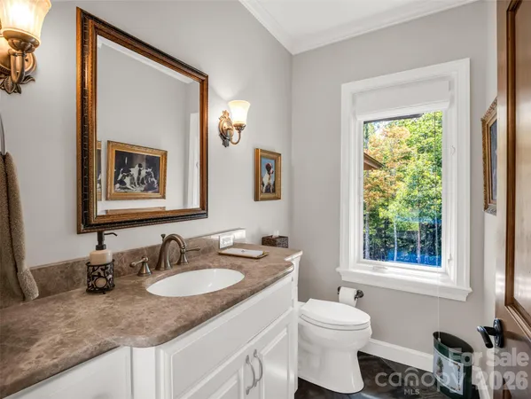 a bed sitting in a spacious bedroom next to a window