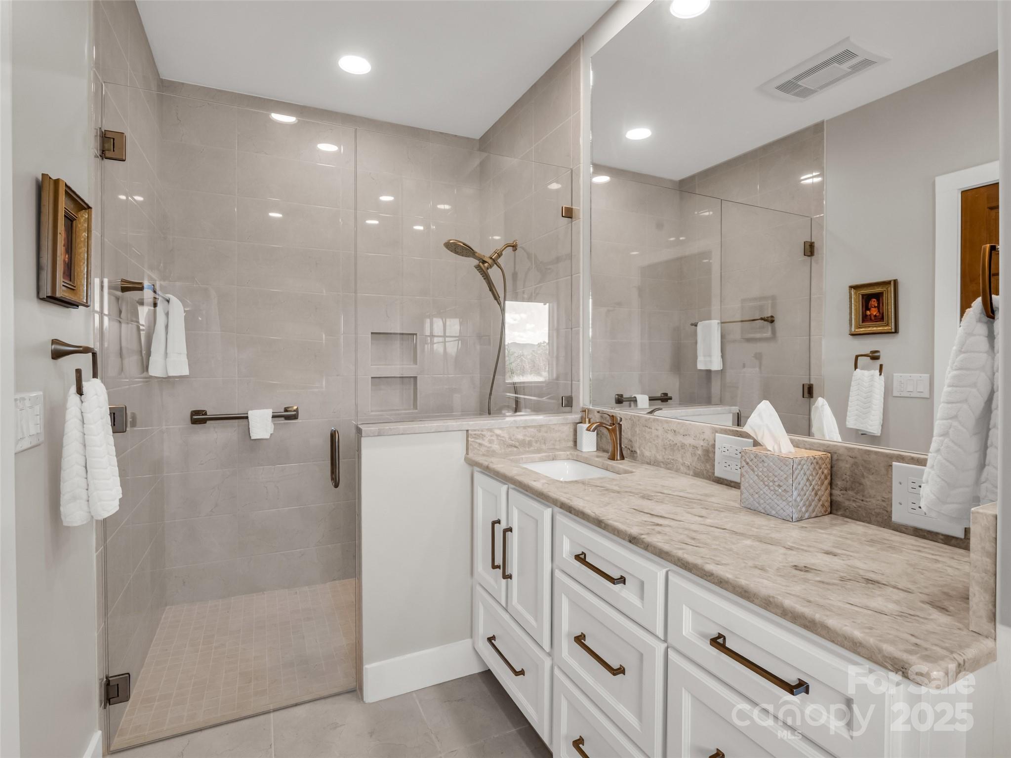 2435 Deep Gap Farm Road East Mill Spring, NC 28756 - Photo 38 of 44 a spacious bathroom with a granite countertop sink mirror and shower