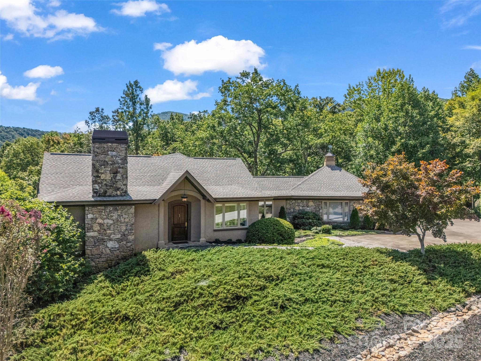 2435 Deep Gap Farm Road East Mill Spring, NC 28756 - Photo 40 of 44 a front view of a house with garden