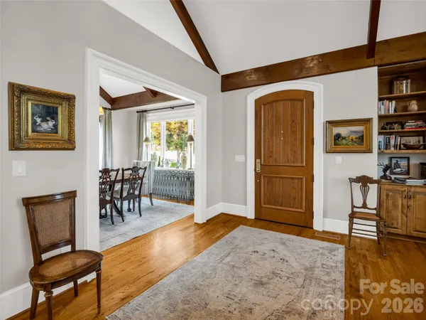 a living room with fireplace furniture and a floor to ceiling window