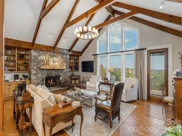 a living room with furniture a flat screen tv and a large window