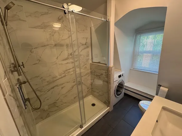 a bathroom with a bathtub and a shower