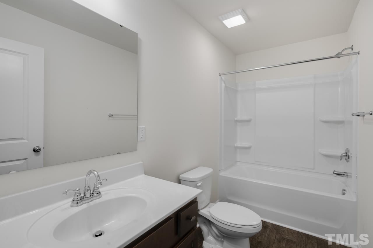 309 Connect Drive Wendell, NC 27591 - Photo 19 of 29 a bathroom with a sink toilet and a bathtub